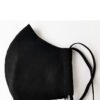 Close-up of a triple-layered face mask; soft fabric texture, reinforced stitching; washable reusable facial garment, shows fi