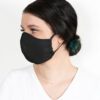 Close-up of a triple-layered face mask; soft fabric texture, reinforced stitching; washable reusable facial garment, shows fi
