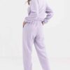 Cozy fleece tracksuit. Half-zip sweat top and basic joggers in a neutral hue. Note the premium stitching and heavy-weight fab