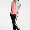 Women's two-piece tracksuit. Zipper hooded top, matching pants. Soft-look fabric, subtle stitching detail. Casual athletic we