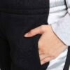 Women's two-piece tracksuit. Zipper hooded top, matching pants. Soft-look fabric, subtle stitching detail. Casual athletic we