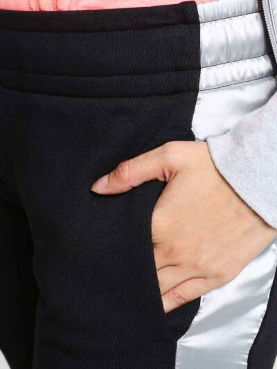 Women's two-piece tracksuit. Zipper hooded top, matching pants. Soft-look fabric, subtle stitching detail. Casual athletic we