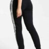 Women's two-piece tracksuit. Zipper hooded top, matching pants. Soft-look fabric, subtle stitching detail. Casual athletic we