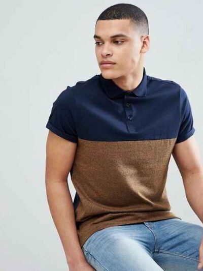Close-up of embroidered polo shirt, fine pique knit texture. Royal blue fabric, crisp white logo stitching. Professional staf