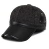 Ear flap baseball cap: PU leather visor, woolen striped panels. Folded ear flaps show stitching. Unisex style, warm fabric. -