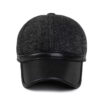 Ear flap baseball cap: PU leather visor, woolen striped panels. Folded ear flaps show stitching. Unisex style, warm fabric. -