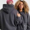 Heather grey unisex hoodie with durable nylon pocket, subtle stitch detailing. Soft, comfortable fleece fabric. Perfect casua