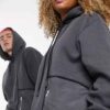 Heather grey unisex hoodie with durable nylon pocket, subtle stitch detailing. Soft, comfortable fleece fabric. Perfect casua