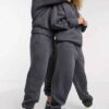 Heather grey unisex hoodie with durable nylon pocket, subtle stitch detailing. Soft, comfortable fleece fabric. Perfect casua