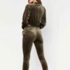 Close-up of a luxurious velour cropped tracksuit. Soft texture, visible stitching, and subtle branding details. A stylish, co