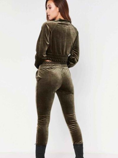 Close-up of a luxurious velour cropped tracksuit. Soft texture, visible stitching, and subtle branding details. A stylish, co