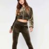 Close-up of a luxurious velour cropped tracksuit. Soft texture, visible stitching, and subtle branding details. A stylish, co