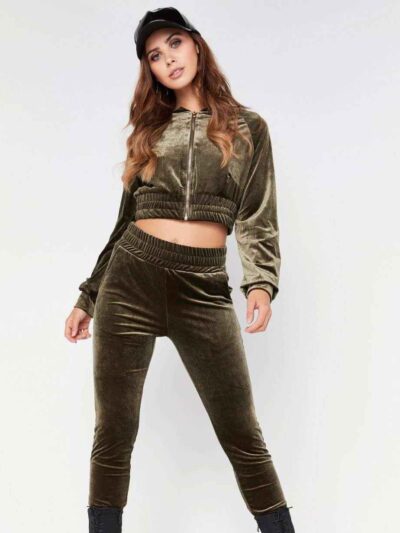 Close-up of a luxurious velour cropped tracksuit. Soft texture, visible stitching, and subtle branding details. A stylish, co