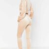Close-up of a luxurious velour cropped tracksuit. Soft texture, visible stitching, and subtle branding details. A stylish, co