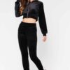 Close-up of a luxurious velour cropped tracksuit. Soft texture, visible stitching, and subtle branding details. A stylish, co