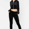 Close-up of a luxurious velour cropped tracksuit. Soft texture, visible stitching, and subtle branding details. A stylish, co