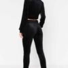 Close-up of a luxurious velour cropped tracksuit. Soft texture, visible stitching, and subtle branding details. A stylish, co