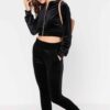 Close-up of a luxurious velour cropped tracksuit. Soft texture, visible stitching, and subtle branding details. A stylish, co