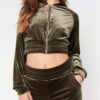 Close-up of a luxurious velour cropped tracksuit. Soft texture, visible stitching, and subtle branding details. A stylish, co