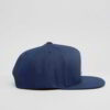 Close-up of a vintage corduroy baseball cap. Notice the soft, ridged texture, embroidered logo, and durable stitching. A casu