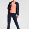 Ladies' vibrant two-piece tracksuit. Soft, stretchy fabric, maybe fleece. Figure-hugging fit, athletic-inspired stitching det