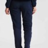 Ladies' vibrant two-piece tracksuit. Soft, stretchy fabric, maybe fleece. Figure-hugging fit, athletic-inspired stitching det