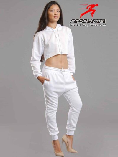 White cotton girls' sweatsuit. Soft, looped interior. Ribbed cuffs & hem. Comfortable fit, visible stitching detail. Sporty &