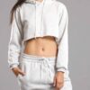 White cotton girls' sweatsuit. Soft, looped interior. Ribbed cuffs & hem. Comfortable fit, visible stitching detail. Sporty &