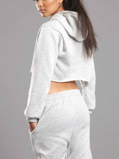 White cotton girls' sweatsuit. Soft, looped interior. Ribbed cuffs & hem. Comfortable fit, visible stitching detail. Sporty &
