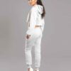 White cotton girls' sweatsuit. Soft, looped interior. Ribbed cuffs & hem. Comfortable fit, visible stitching detail. Sporty &