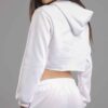 White cotton girls' sweatsuit. Soft, looped interior. Ribbed cuffs & hem. Comfortable fit, visible stitching detail. Sporty &