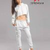 White cotton girls' sweatsuit. Soft, looped interior. Ribbed cuffs & hem. Comfortable fit, visible stitching detail. Sporty &