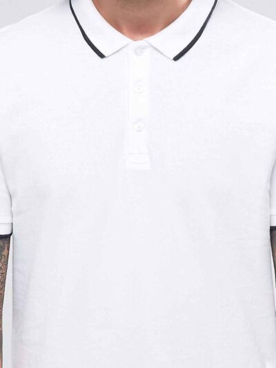 Close-up of a navy blue polo shirt with custom embroidered logo. Smooth knit texture, clean stitching details, classic pique