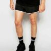Quick-dry beach shorts: vibrant print, polyester weave detail, sturdy seams. Men's swimwear, customizable with logo. Light bl