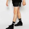 Quick-dry beach shorts: vibrant print, polyester weave detail, sturdy seams. Men's swimwear, customizable with logo. Light bl