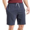Close-up: Textured swim trunks. Quick-dry fabric, subtle print detail. Board shorts with reinforced stitching & adjustable dr