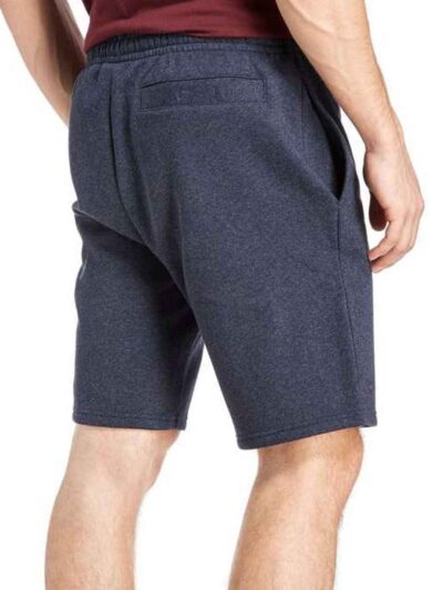 Close-up: Textured swim trunks. Quick-dry fabric, subtle print detail. Board shorts with reinforced stitching & adjustable dr