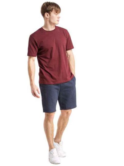Close-up: Textured swim trunks. Quick-dry fabric, subtle print detail. Board shorts with reinforced stitching & adjustable dr