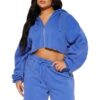 Women's tracksuit set: hooded zip jacket and jogger pants. Soft, textured fabric, clean stitching. Subtle color variations vi