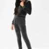 Slim fit grey velour tracksuit. Soft texture visible. Note customized logo printing, subtle stitching detail. Comfortable lou