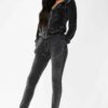 Slim fit grey velour tracksuit. Soft texture visible. Note customized logo printing, subtle stitching detail. Comfortable lou