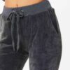 Slim fit grey velour tracksuit. Soft texture visible. Note customized logo printing, subtle stitching detail. Comfortable lou