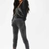 Slim fit grey velour tracksuit. Soft texture visible. Note customized logo printing, subtle stitching detail. Comfortable lou