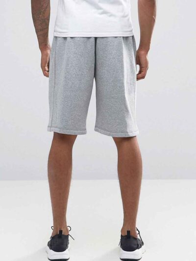 Durable polyester sports shorts in vibrant color; close-up shows reinforced stitching and breathable fabric texture. Ideal sc