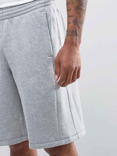 Durable polyester sports shorts in vibrant color; close-up shows reinforced stitching and breathable fabric texture. Ideal sc
