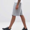 Durable polyester sports shorts in vibrant color; close-up shows reinforced stitching and breathable fabric texture. Ideal sc