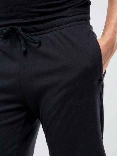 Summer jogger shorts in a light, breathable fabric. Note the elastic waistband, drawstring, and clean stitching. Perfect for