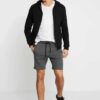 Men's lightweight cotton short set, ideal for summer. Soft textured fabric, precise stitching. Casual two-piece, light color,