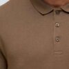 Close-up of a textured polo shirt. Fine pique knit, reinforced stitching, vibrant color hints. Customizable with your logo. -