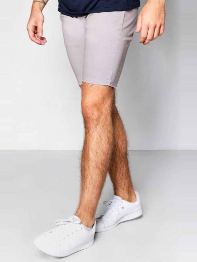 Close-up of athletic shorts. Smooth, flexible fabric, reinforced stitching. Deep black with subtle reflective accents. Workou
